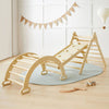 Wooden climbing toy set with a curved slide and pyramid structure on a light wooden floor.
