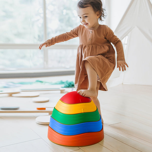 Child playing with a colorful stacking toy indoors