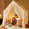 Children's playhouse with curtains and fairy lights in a cozy room.