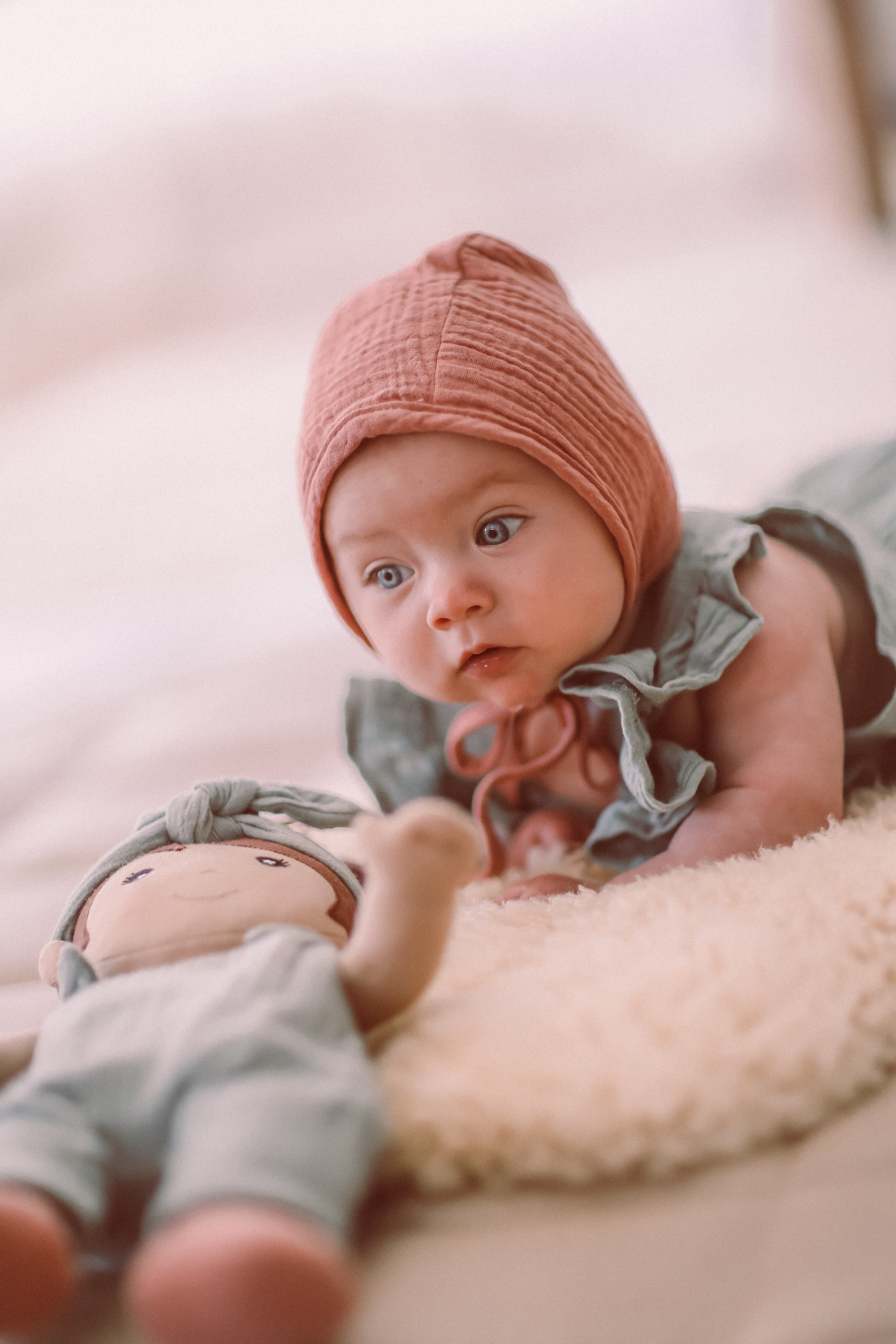 Detail shot of teal organic muslin baby romper showing flutter sleeves and soft OEKO-TEX certified fabric