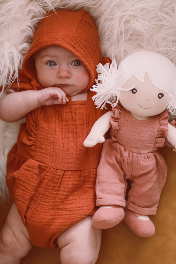 Rust muslin flutter sleeve romper and bonnet set styled with Chloe Park Friend soft toy