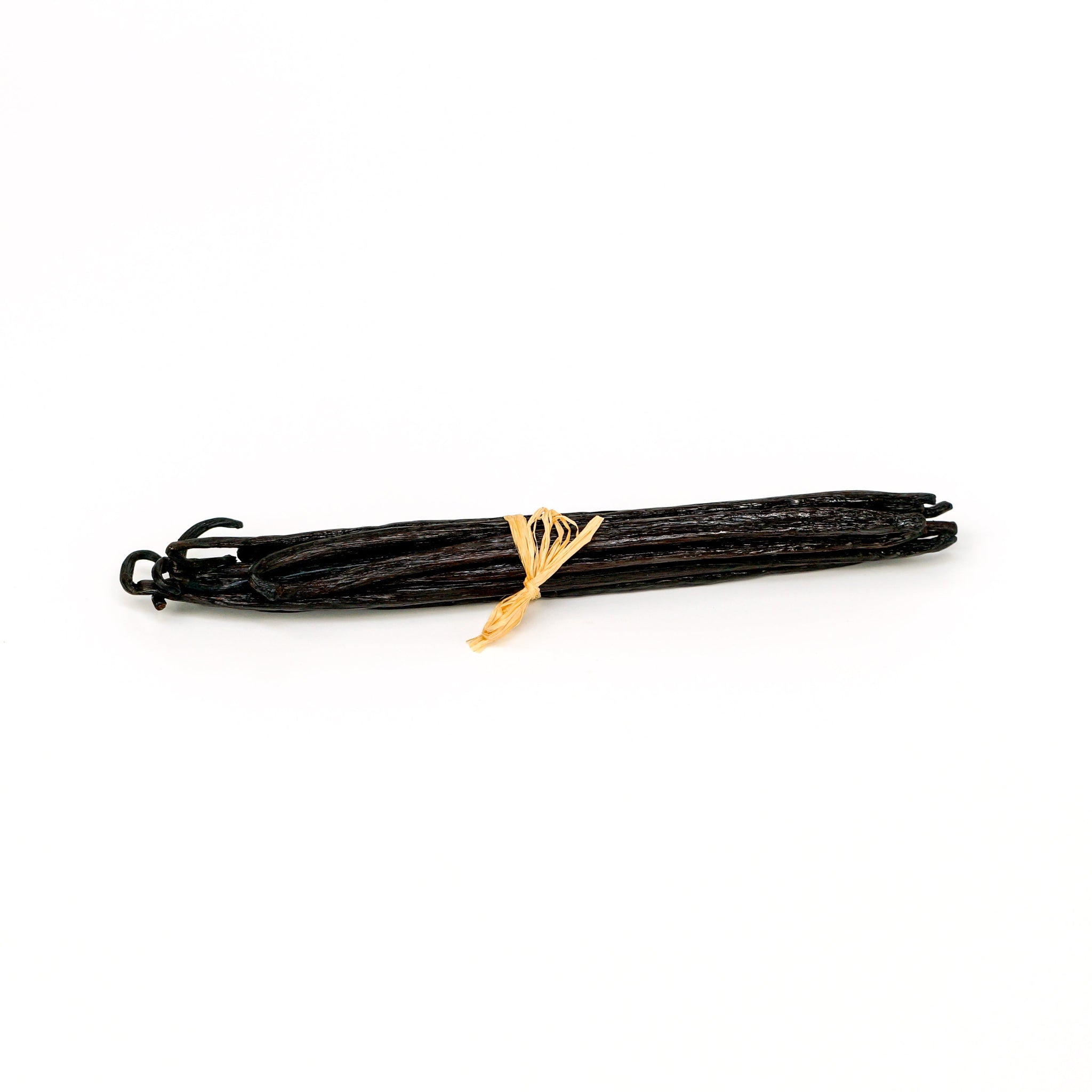Bunch of vanilla beans tied with a yellow string on a white background