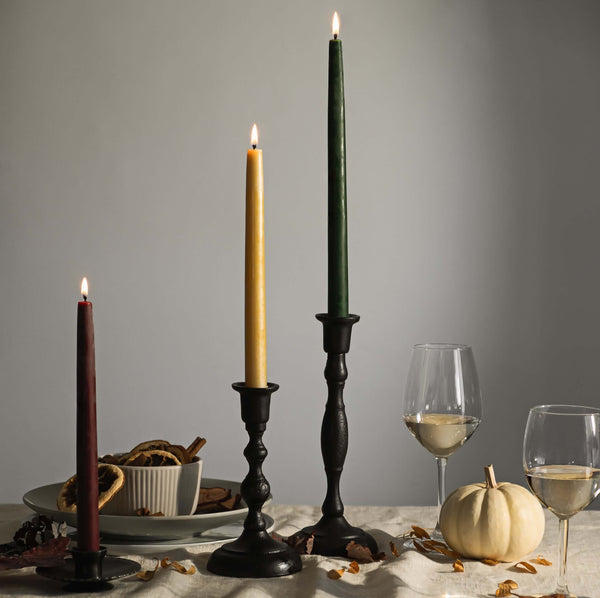 Thanksgiving tablescape styled with cast iron taper holders and lit beeswax taper candles