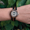 Close-up of Tree of Life wooden watch with Vegvisir engraving and zebra wood and ebony band