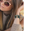 Woman wearing striped woven palm leaf cuff bracelet styled as a gift accessory