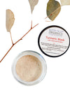 Turmeric Face Mask by Butter Me Up Organics displayed with natural ingredients including calendula flowers and turmeric