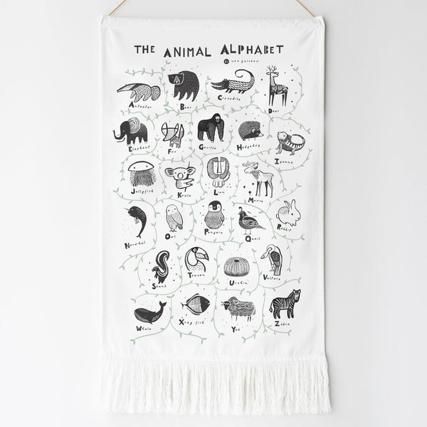 White wall hanging with black animal illustrations and text on a white background
