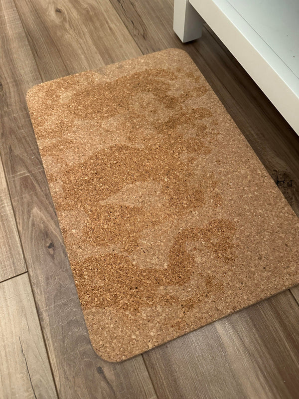 Brown cork bathroom mat on a wooden floor