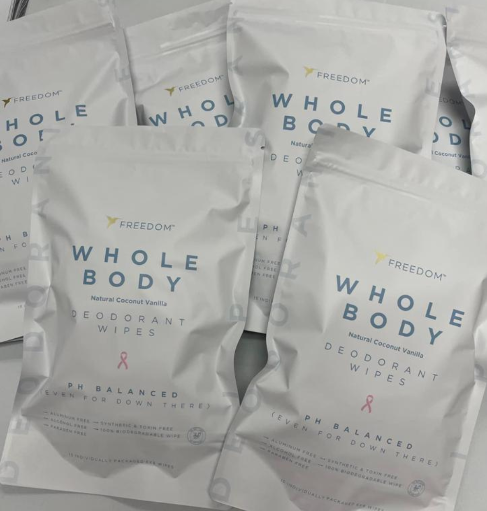 Multiple packages of Freedom Whole Body deodorant wipes on a light background