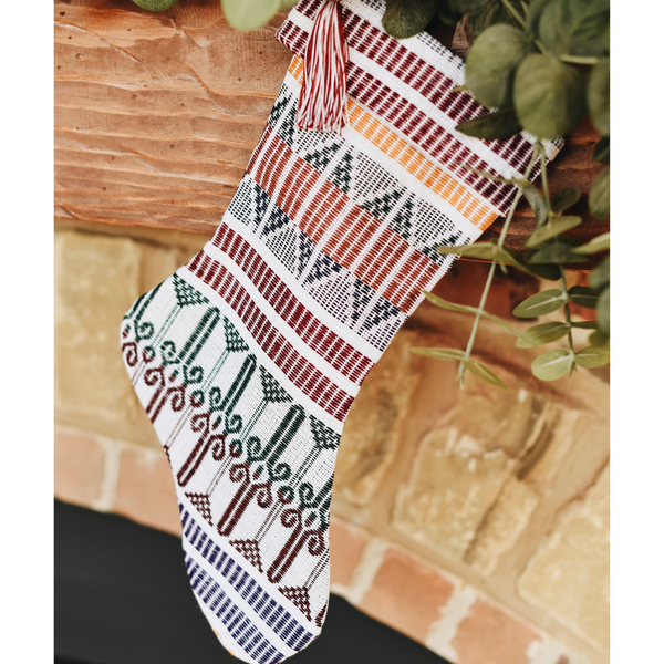 Decorative Christmas stocking with geometric pattern on a wooden surface