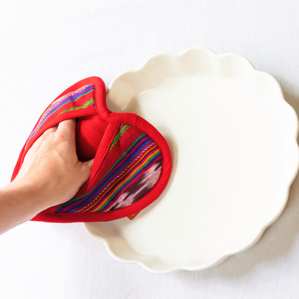 Protect your hands with love using our Heart-Shaped Pot Holder. This adorable and functional kitchen accessory is perfect for any occasion and supports fair trade practices.