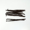 Vanilla beans arranged on a white background