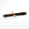 Bunch of vanilla beans tied with a ribbon on a white background