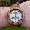 Custom Norse wooden watch showing back engraving with personalized message and Valknut knotwork