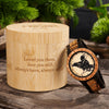 Wooden watch with engraved design and Viking Buds branded box on a wooden surface with plants in the background