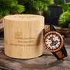 Wooden watch with engraved message in a wooden box on a rustic surface