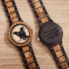 Wooden watches with engraved designs on a wooden surface