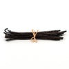 Bunch of vanilla beans tied with a rubber band on a white background