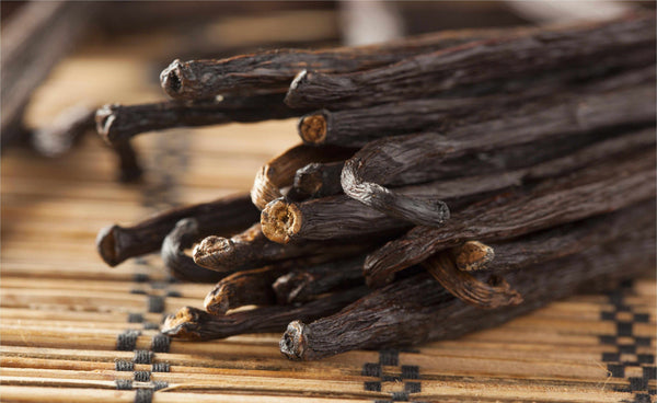 Cloves on a wooden surface. Craft your own gourmet vanilla extract with our USDA Organic Grade B Madagascar Vanilla Beans. These high-quality, non-GMO vanilla pods are a cost-effective way to get rich, creamy flavor for all your baking needs.