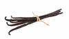 Vanilla beans tied together with a string on a white background