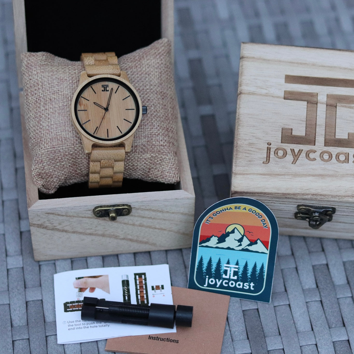 Wooden watch in a box with a Joycoast logo and branding elements.