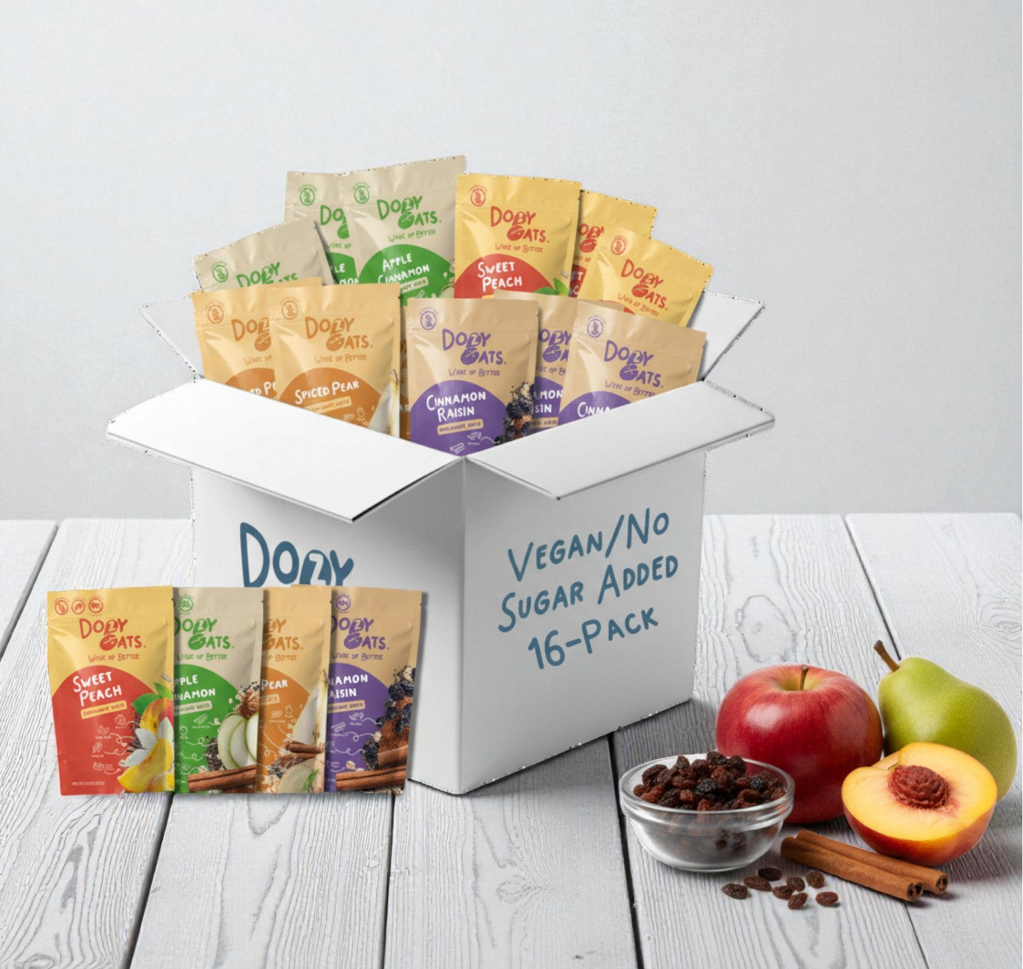 Box of Dové Oats vegan/no sugar added 16-pack with various flavors on a white background.