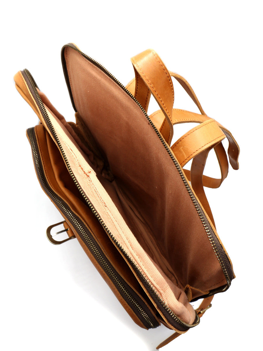 Brown leather bag with a strap on a white background