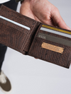 Brown cork wallet with card slots on a light gray background