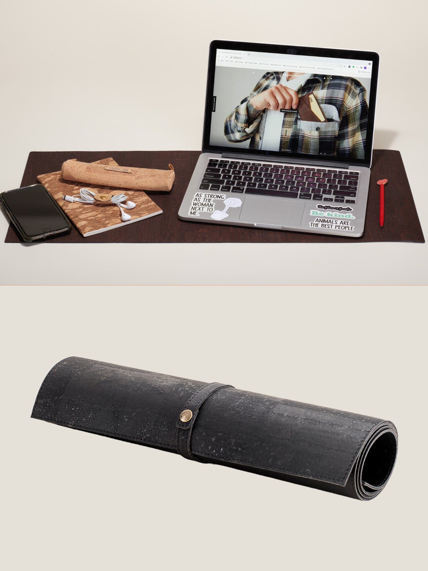 Roll-up leather desk organizer with laptop, phone, and stationery on a desk.