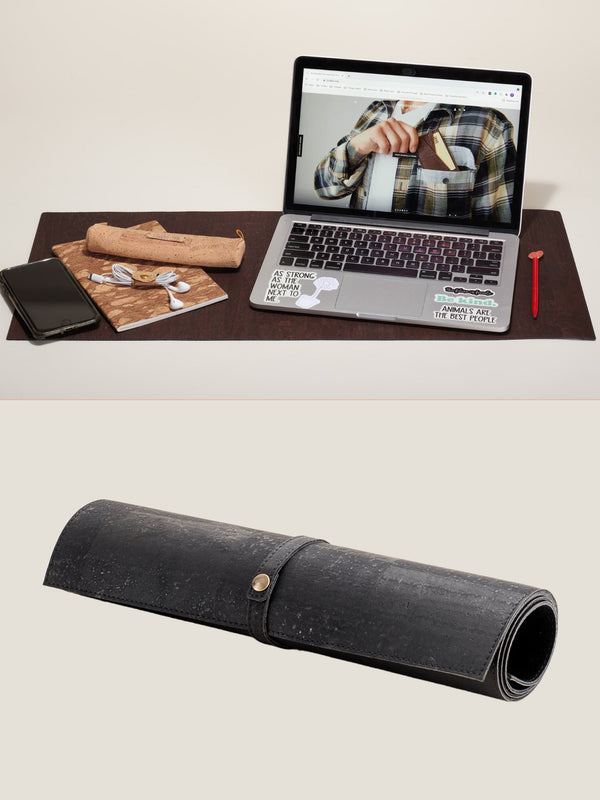 Roll-up leather desk organizer with laptop, phone, and stationery on a desk.