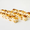 Two nougat bars with nuts on a white background