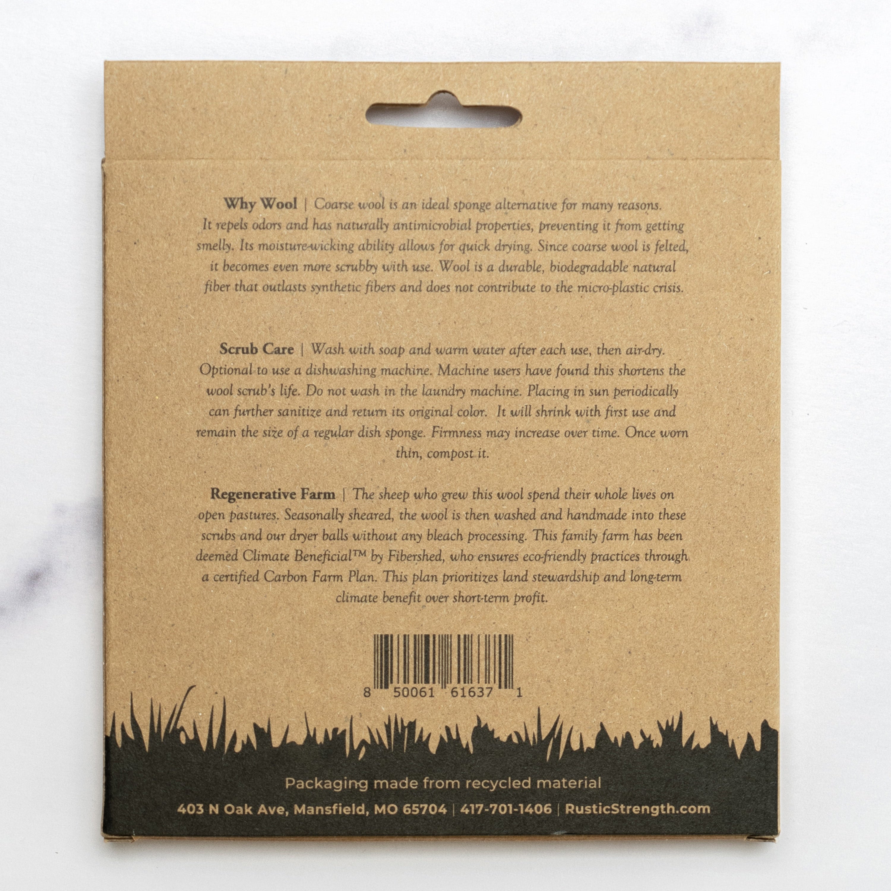 Back of a cardboard package with text and a barcode on a white background