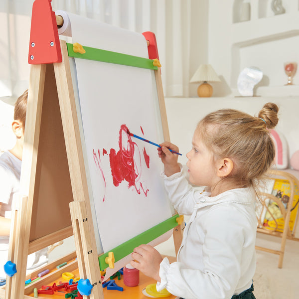 Child painting on a wooden easel with colorful paint and brushes.