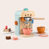 Toy espresso machine with accessories on a light background