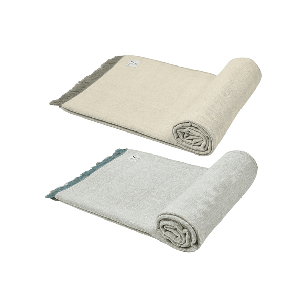 Two folded blankets, one beige and one gray, on a white background
