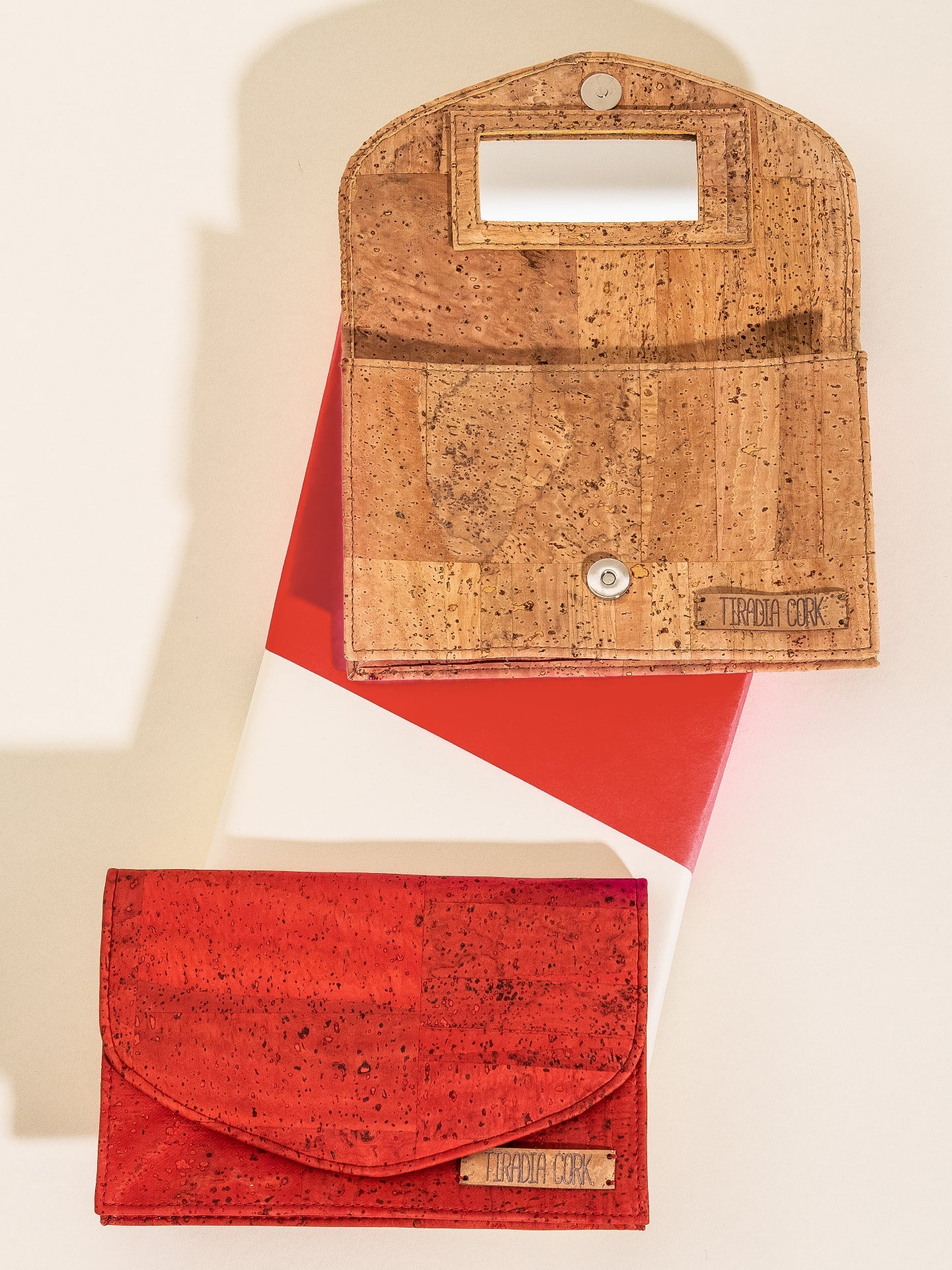Two cork bags, one red and one brown, on a white background