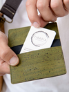 Green cork wallet with a card being inserted, branded 'Tiradia'.