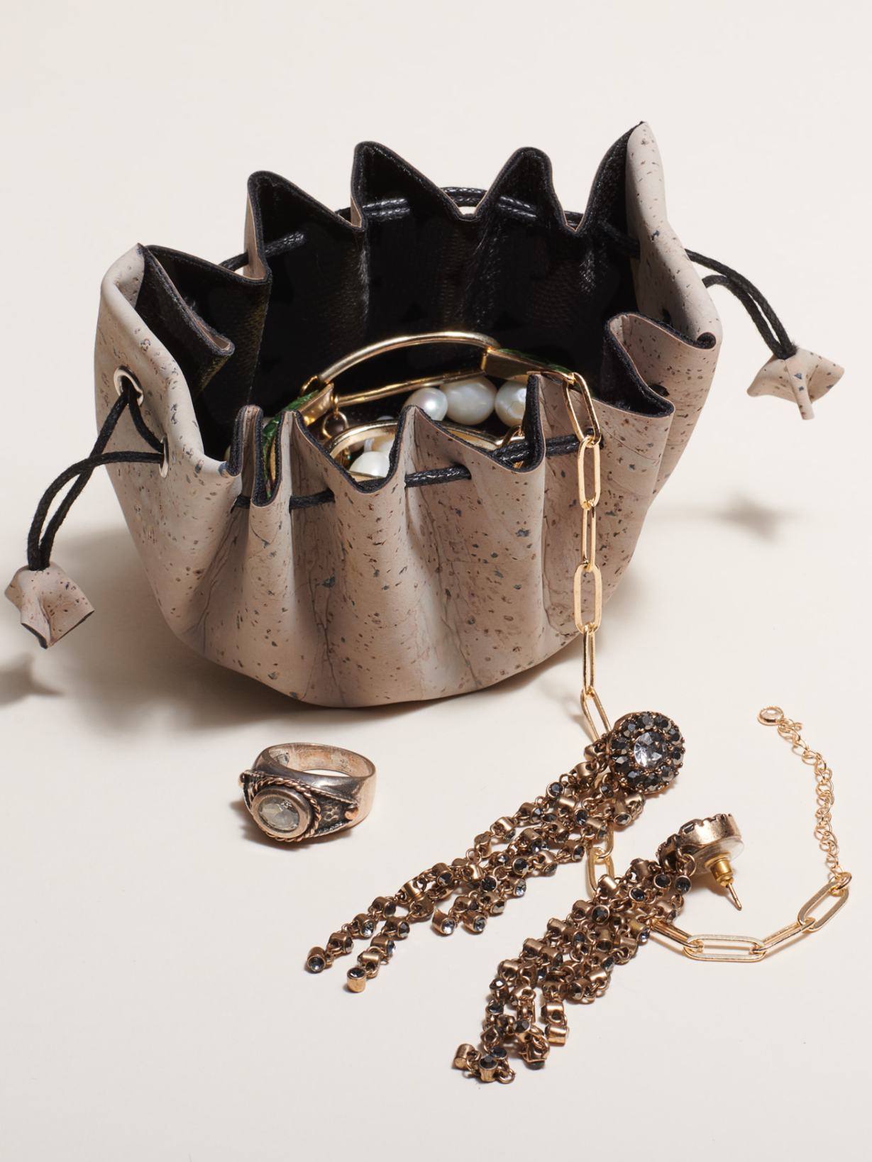 Porto cork travel pouch alongside jewelry accessories — eco-friendly gift idea for travelers