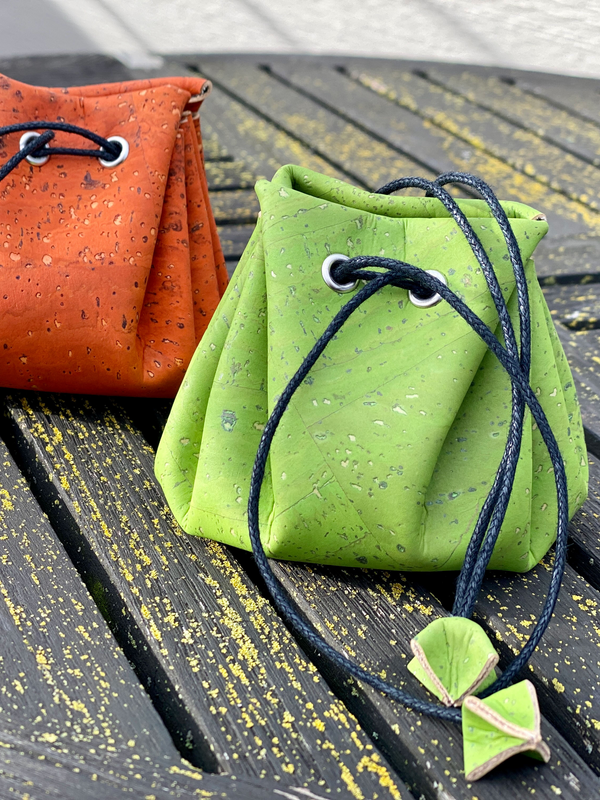 Sustainable cork jewelry travel organiser pouch sitting flat on a neutral surface