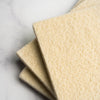 Close-up detail of felted wool scrub texture showing natural fibres and scrubbing surface