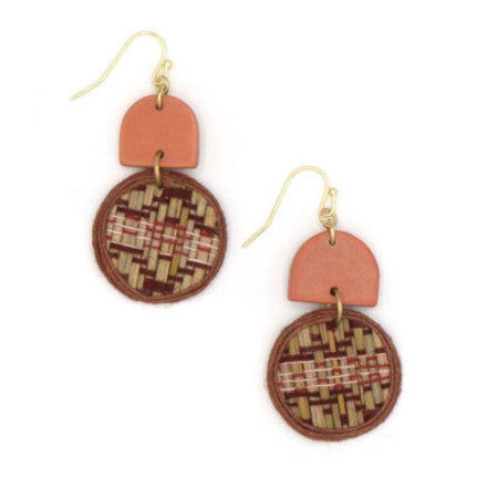 Pair of earrings with circular patterned drops and pinkish-brown geometric shapes on a white background
