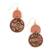 Pair of earrings with circular patterned drops and pinkish-brown geometric shapes on a white background