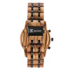Wooden watch with black accents on a white background, featuring the brand 'joycoast'.