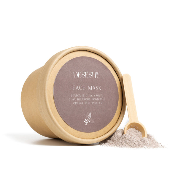Desesh mineral powder face mask in compostable plastic-free packaging with bamboo spoon and brightening clay blend powder shown