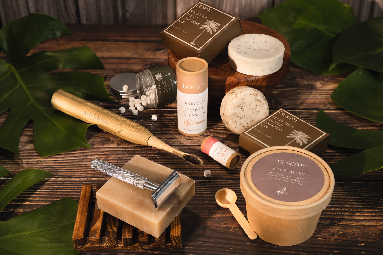 Collection of natural skincare and grooming products on a wooden surface with green leaves.