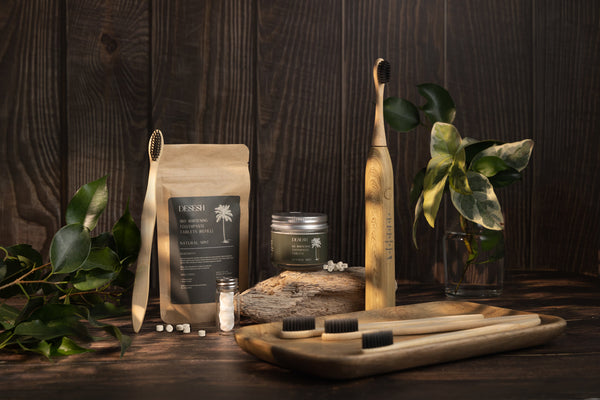 Eco-friendly dental care products including Desesh toothpaste tablets, biodegradable floss and bamboo toothbrush