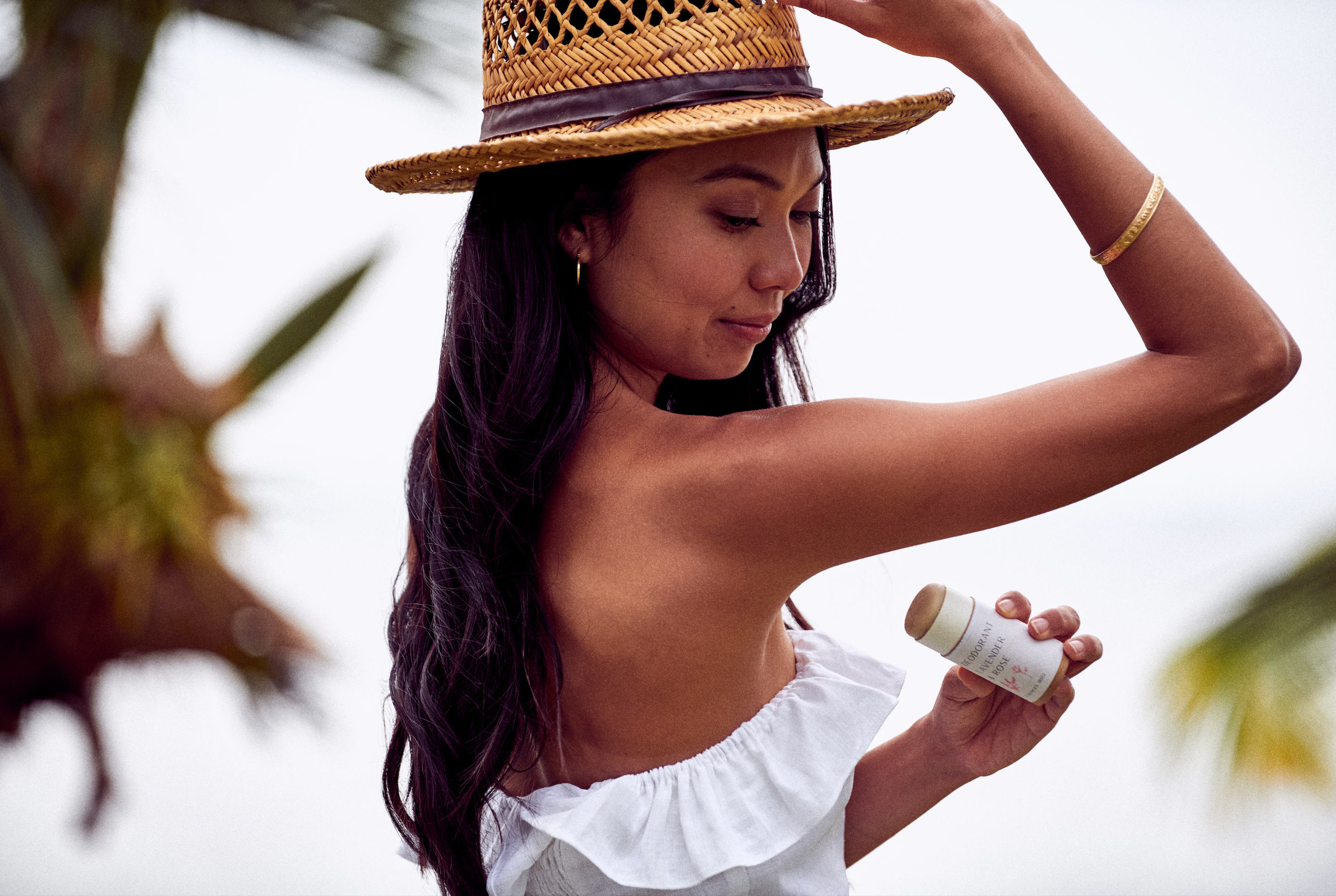 Woman applying Desesh zero waste plastic free natural aluminum free deodorant – sustainable eco-friendly personal care