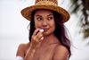 Woman applying Desesh natural vegan lip balm – sustainable plastic-free lip care made in the USA