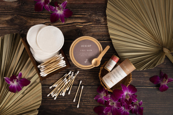Reusable cotton makeup remover pads by Desesh displayed with sustainable skincare products including deodorant, lip balm, face mask, and bamboo ear swabs