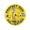 Close-up of the embossed metal pollinator garden sign showing detailed bee, butterfly, and bird design on a round aluminium panel